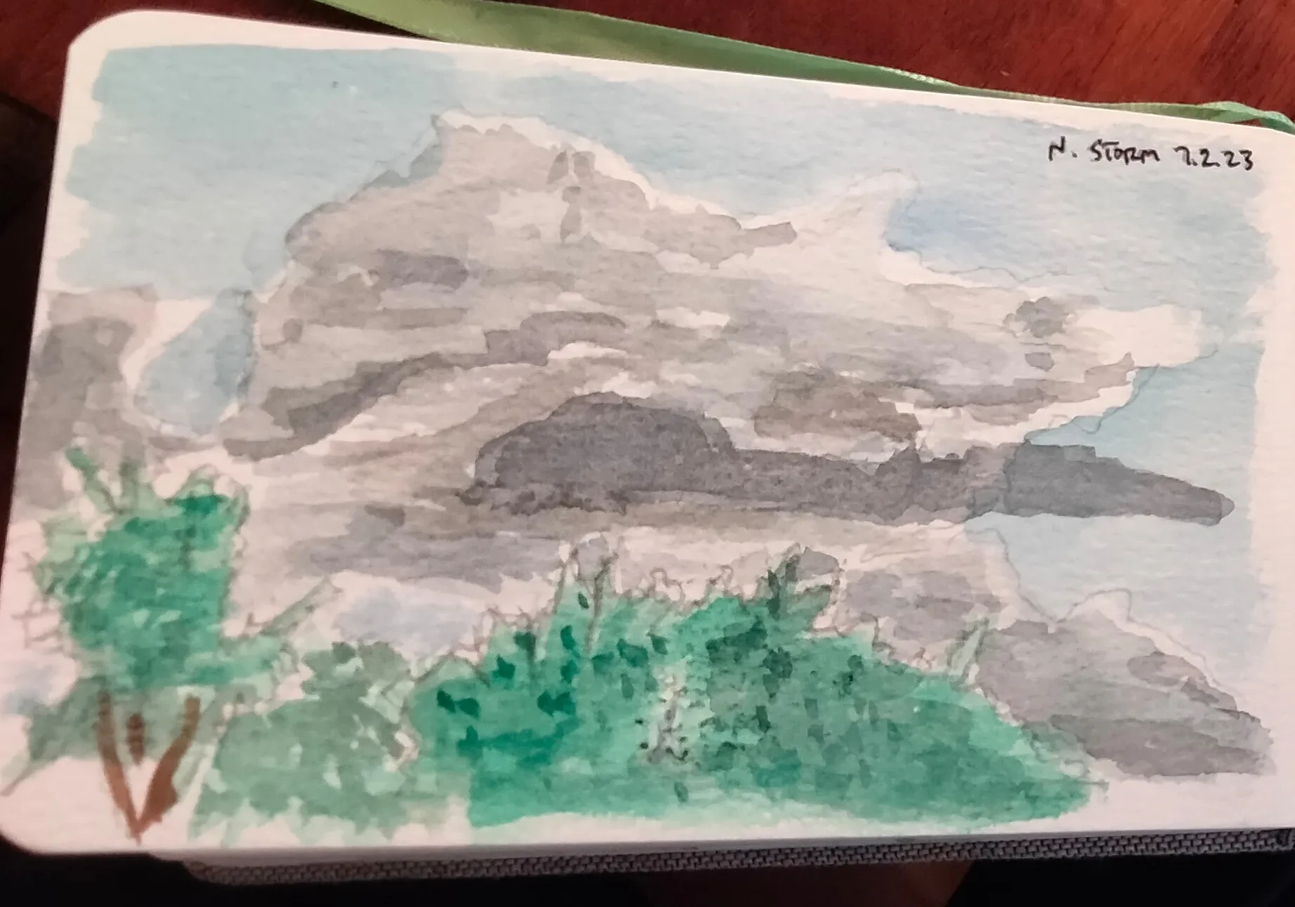 A watercolor sketch of a field and a large thunderstorm north of the viewer.