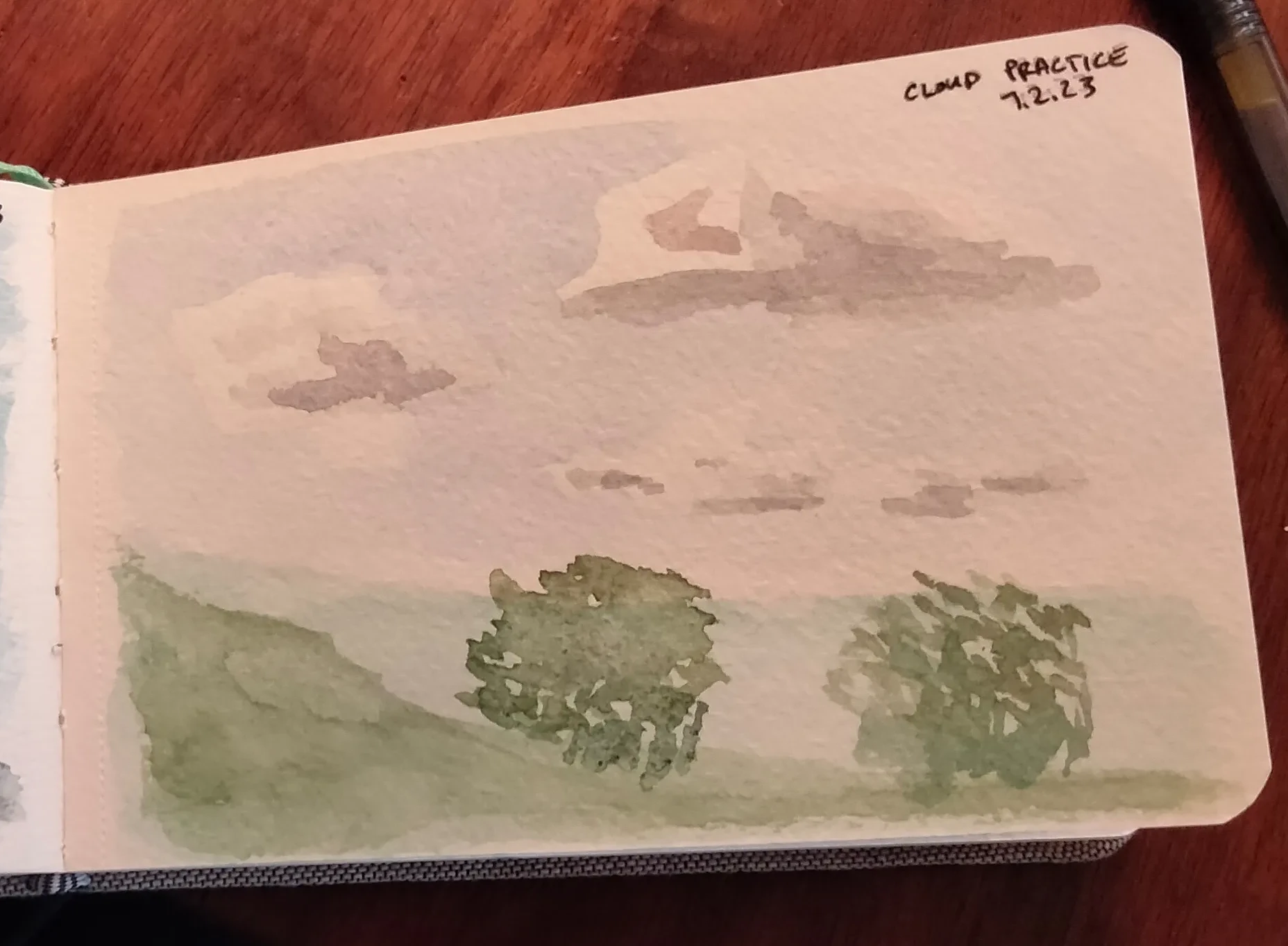 A watercolor painting of clouds floating high on a pale blue sky.